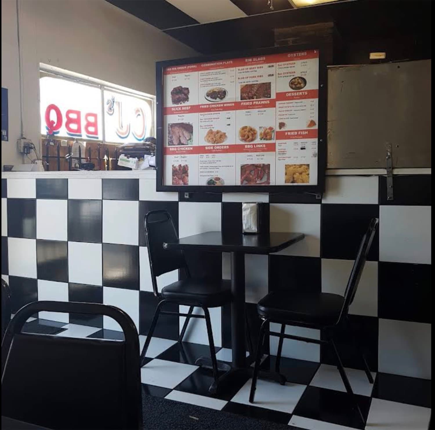 Inside the Richmond CJ's, checkerboard walls and the lit menu board